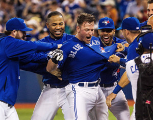 Toronto Blue Jays Josh Donaldson is mobbed by his teammates as he celebrates hitting the winning home run in the 10th inning against the Atlanta Braves during MLB action in Toronto Saturday, April 18, 2015. THE CANADIAN PRESS/Aaron Vincent Elkaim