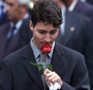 CITY--Oct 3/00--Trudeau6--Justin Trudeau puts the rose that was lying on his father's coffin to his nose as he walks out of the church.  (Gazette-Pierre Obendrauf) DIGITAL IMAGE- Justin Trudeau sniffed a rose that was lying on his father's casket as he walked out of Notre Dame Basilica after the two-hour funeral yesterday.  // JUSTIN TRUDEAU DAZZLED THE NATION IN FUNERAL SPEECH. - Justin Trudeau  Justin Trudeau moved hearts.   ORG XMIT: POS2013040414000738